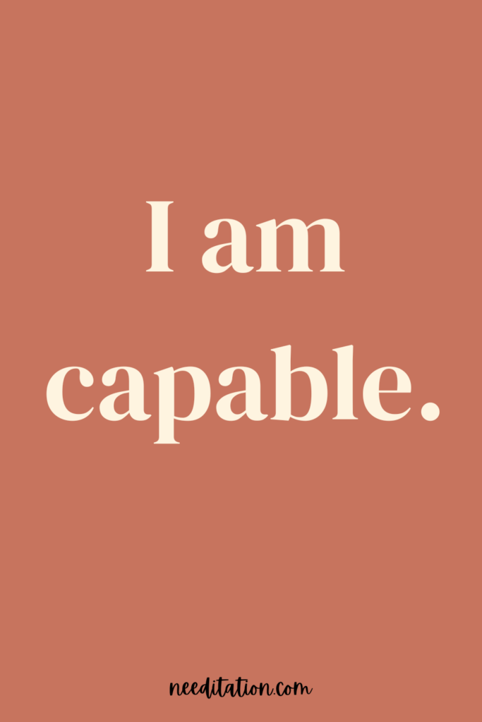 a short positive mantra on a red background that reads "I am capable"